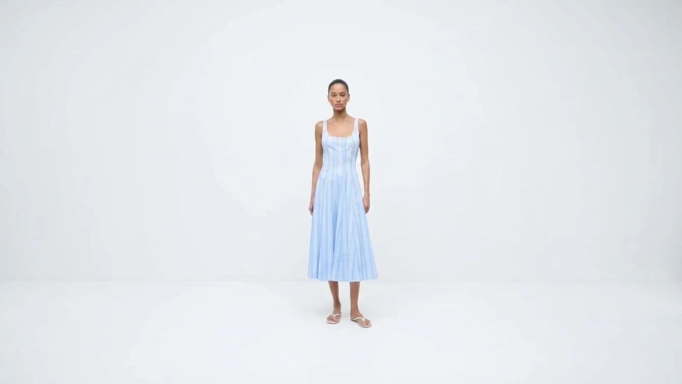 Model wearing a blue and white striped midi dress.