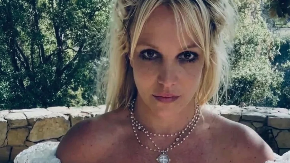 Britney Spears in a white off-the-shoulder dress.