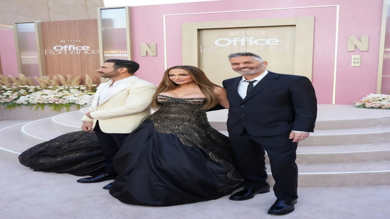 Jennifer Lopez posed with her Office Romance co-star at the Netflix premiere wearing a black Atelier Versace gown in Hollywood.