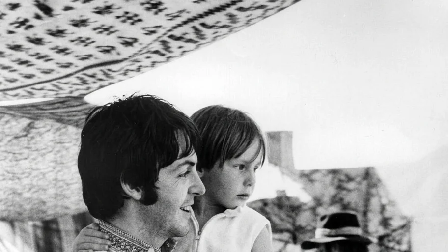 Beatles singer and bass player Paul McCartney holds four year old Julian, son of his colleague John Lennon (visible in the background) during a holiday near Athens in Greece.   (Photo by Central Press/Getty Images)