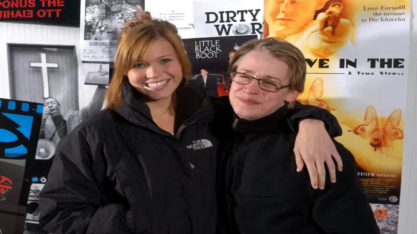 Mandy Moore and Macaulay Culkin smiling and embracing at the 2004 Sundance Film Festival.