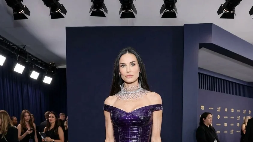 Demi Moore wore a purple croc-embossed Gucci gown with Boucheron jewellery to the Kering Women In Motion dinner at Cannes.