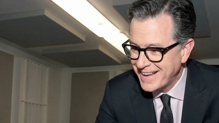 Stephen Colbert signing autographs.