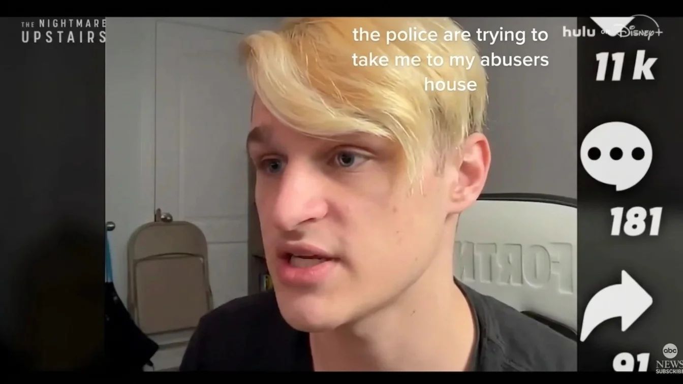 A person with blonde hair and blue eyes speaking into the camera with text overlay "the police are trying to take me to my abusers house".