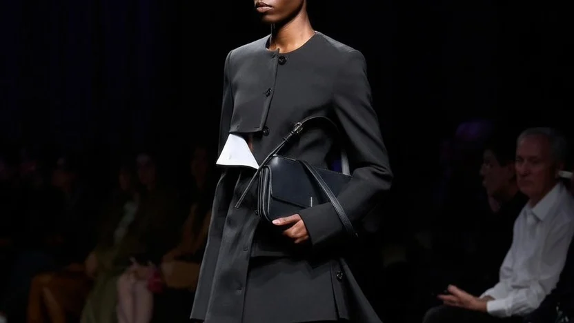 Ferragamo Fall 2026 black wool jacket and skirt with contrasting mascarpone panels on the runway.